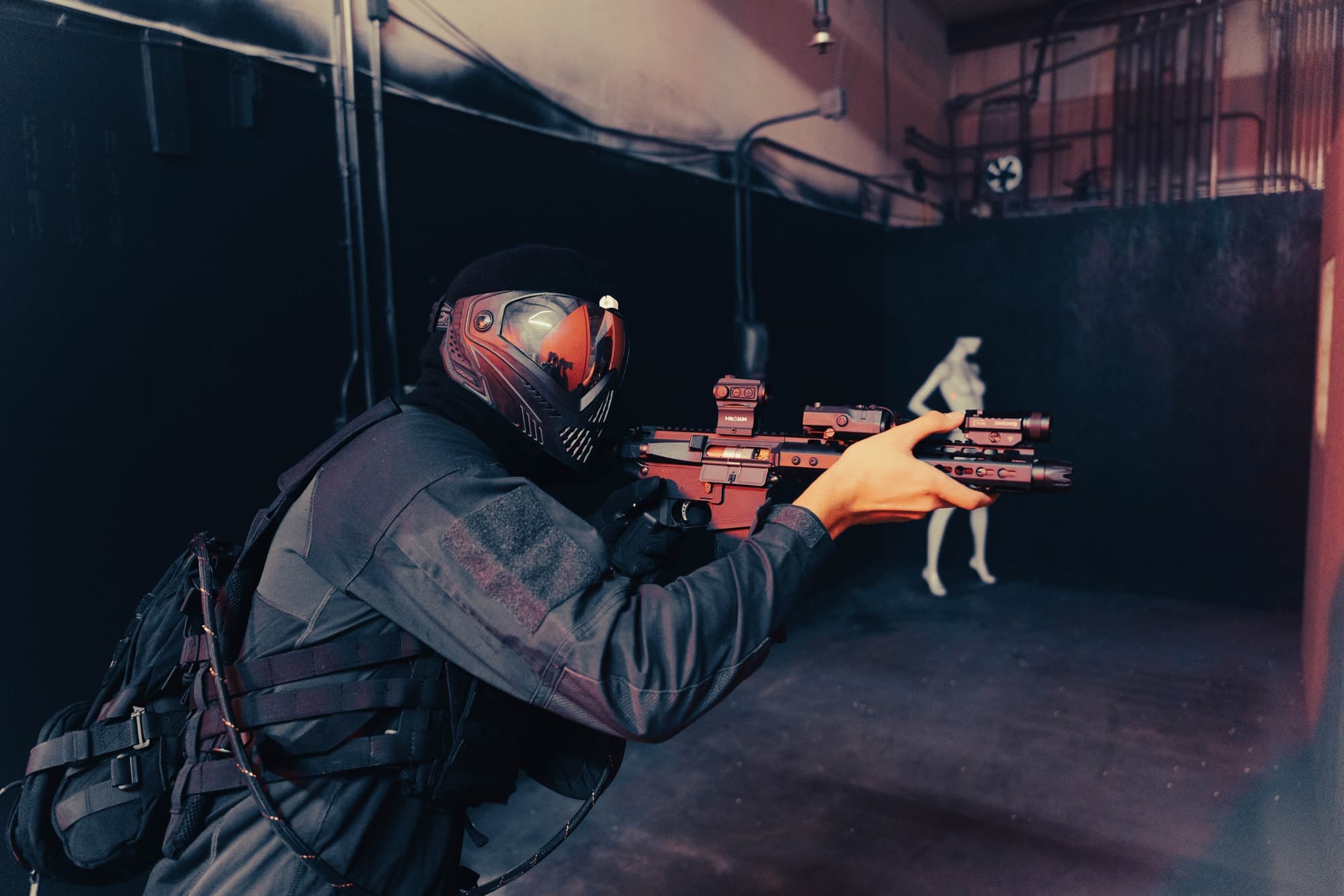 Close-up of a masked player aiming inside the CQB arena