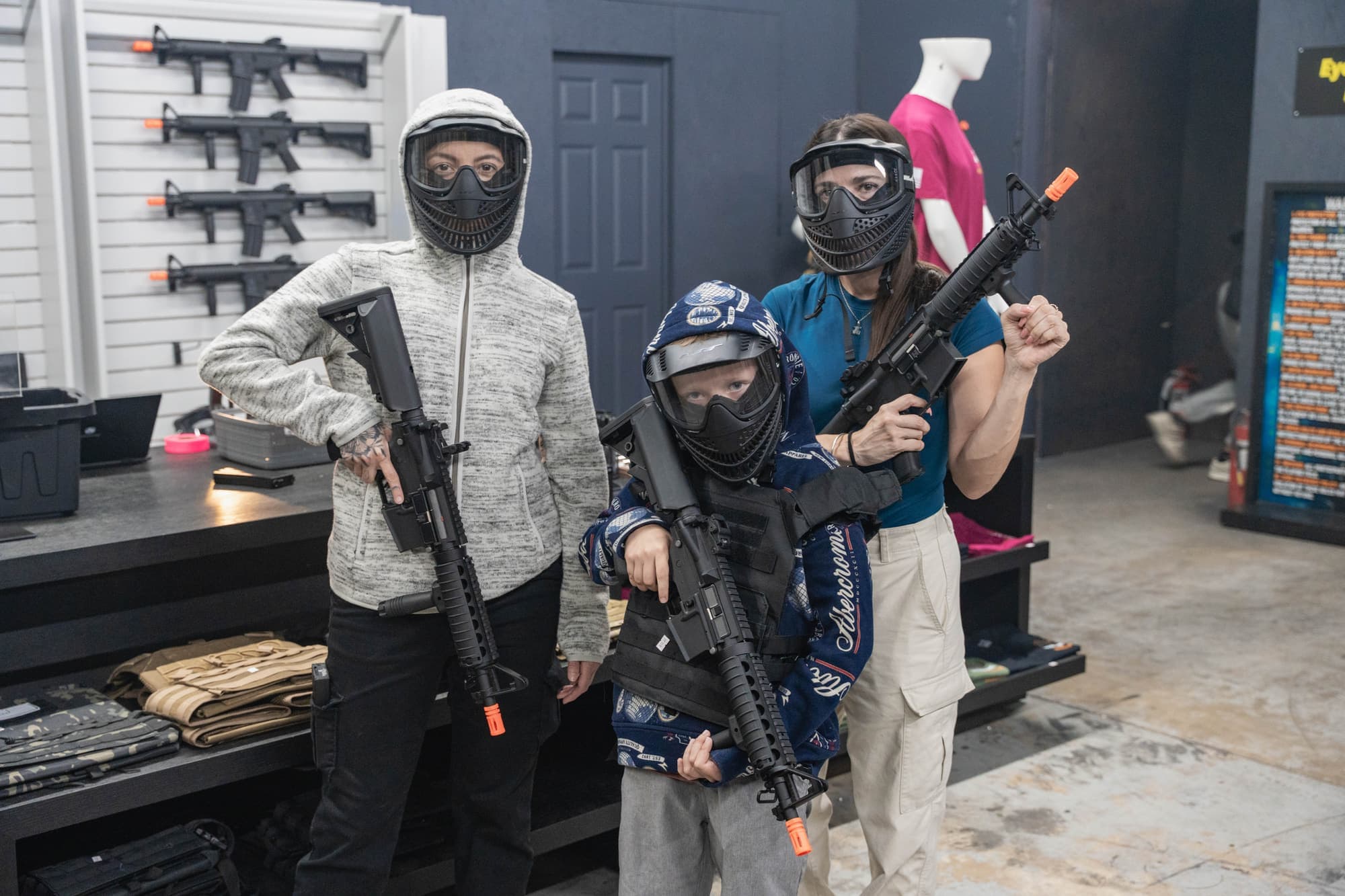 Young players and an adult posing with rental gear in the lobby